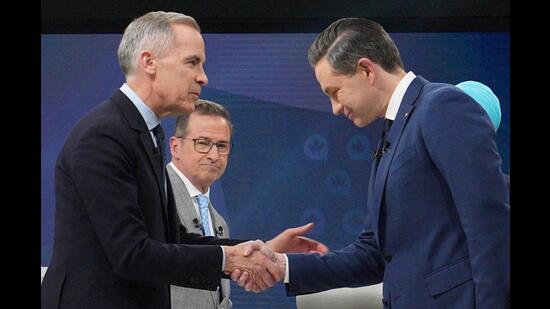 Liberal Leader Mark Carney shakes hands with Conservative Leader Pierre Poilievre following the French-language federal leaders' debate, in Montreal, on Wednesday. (REUTERS)
