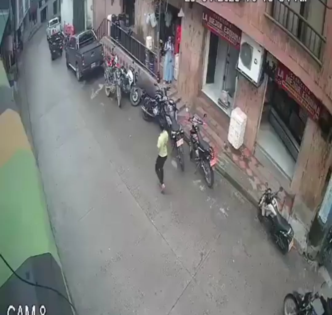 Two FARC militants throw an explosive device at a police station and are quickly shot dead by a police officer. Cali, Valle del Cauca, colombia, April 25, 2025