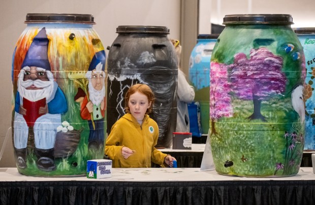 Finnigan Kietzman, 8, tries to decide which decorated rain barrel to vote for during the 2025 Northwest Indiana Earth Day celebration at the Porter County Expo Center in Valparaiso, Indiana, Saturday, April 12, 2025. (Andy Lavalley/for the Post-Tribune)