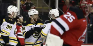 David Pastrnak scores a goal in the first period against Jacob Markstrom and the New Jersey Devils in Newark, New Jersey.