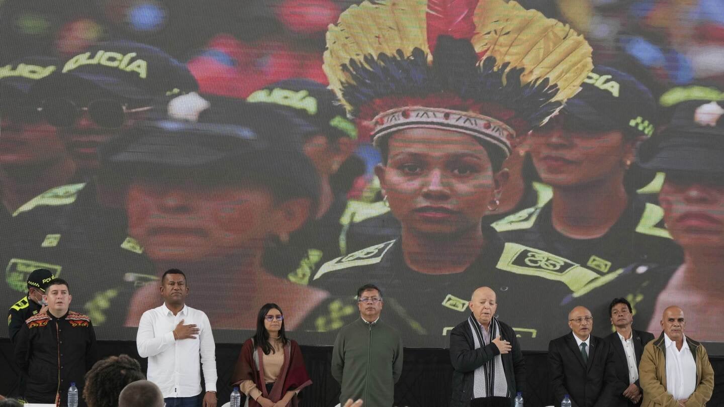 A rebel group begins handing weapons over to the Colombian government as peace talks advance
