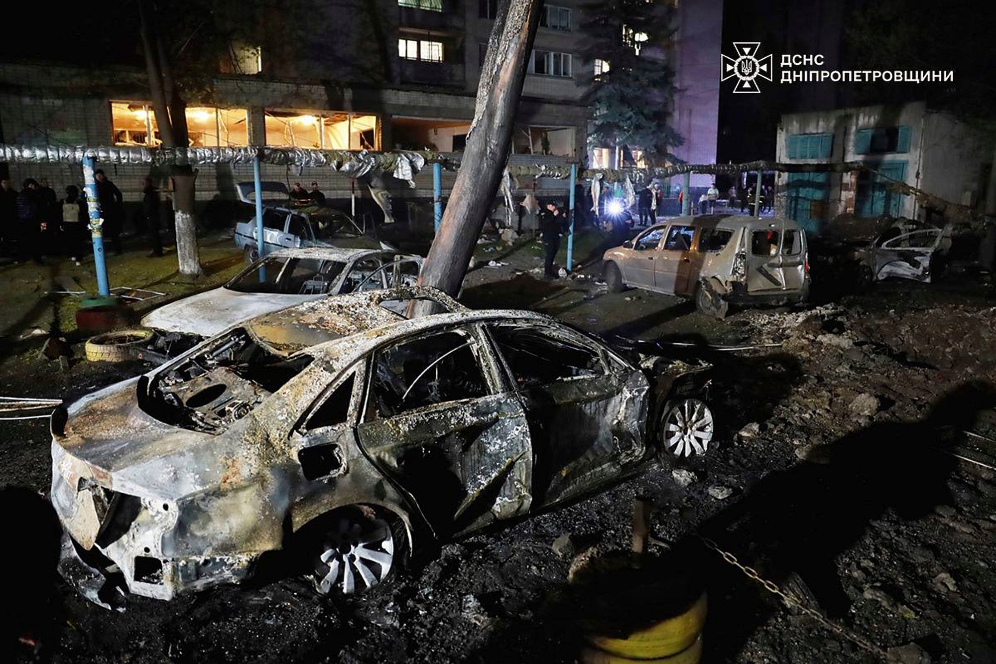 In this photo, provided by the Ukrainian Emergency Service, firefighters extinguish fire following a Russian attack in Dnipro