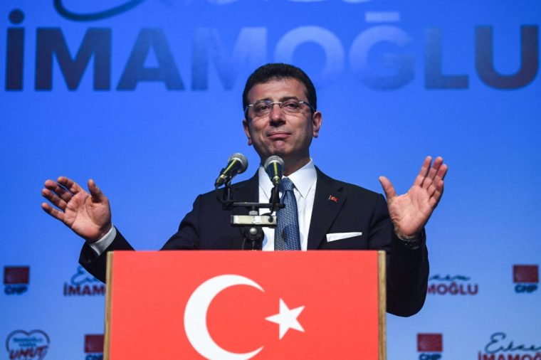 (FILES) Turkish opposition candidate for the Istanbul re-run for the mayor's election, Ekrem Imamoglu gestures as he delivers a speech on stage during his repeated political campaign coordination meeting on May 22, 2019 in Istanbul. Turkish police raided the home of Istanbul Mayor Ekrem Imamoglu on March 19, 2025, detaining him over a corruption probe in a move denounced by the main opposition CHP party as a "coup". (Photo by OZAN KOSE / AFP) (Photo by OZAN KOSE/AFP via Getty Images)