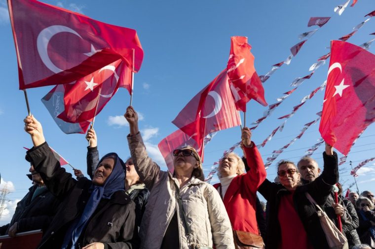 ANKARA, TURKEY - APRIL 6: People wave flags and chant slogans as they listen CHP leader Ozgur Ozel after the CHP???s on April 6, 2025 in Ankara, Turkey. Ozgur Ozel, leader of the Republican People's Party (CHP), called an extraordinary congress, the move comes amid concerns that the party leadership could be removed through legal action after the arrest of the Mayor of Istanbul, Ekrem Imamoglu. The Mayor of Istanbul Ekrem Imamoglu, a member of opposition Republican People's Party (CHP) and the main challenger in the next presidential election, was jailed on corruption charges, sparking the country's largest wave of demonstrations since the 2013 Gezi Park protests. (Photo by Serdar Ozsoy/Getty Images)