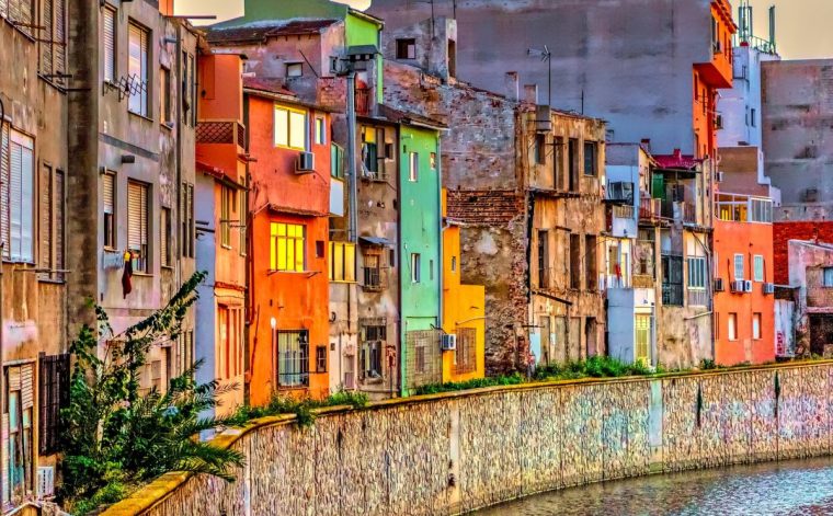 View of colorful homes in picturesque Orihuela, Spain, next to Segura river.