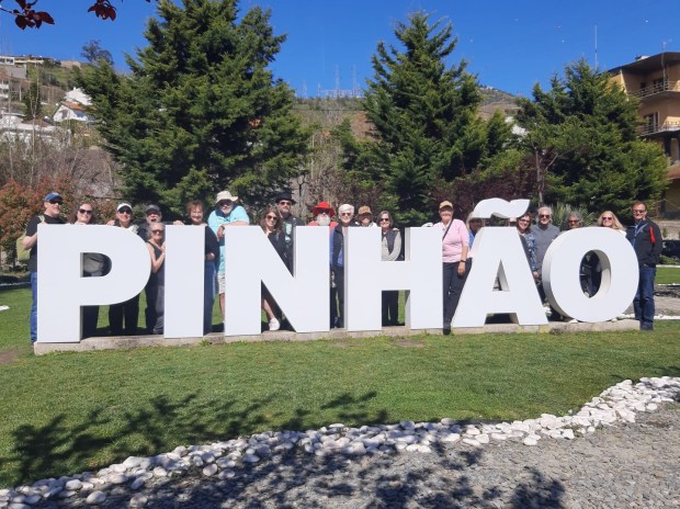 A group behind giant letters reading PINHAO