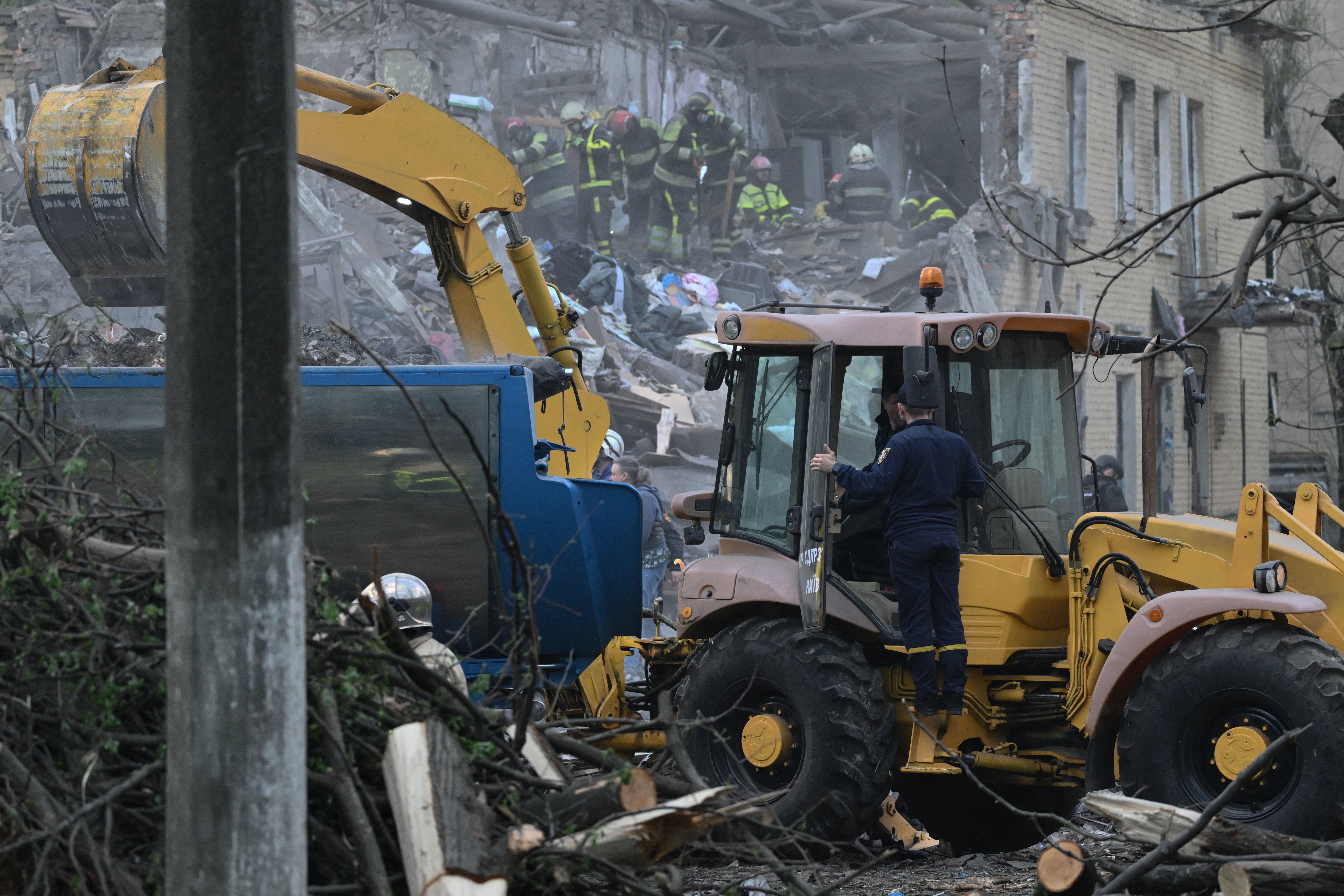 Ukrainian rescuers operate at the site of a Russian missile attack in Kyiv on 24 April 2025, amid the Russian invasion of Ukraine