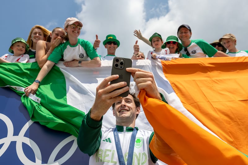 Ireland's Paul O'Donovan taking a selfie with supporters after receiving a gold medal. Photograph: Morgan Treacy/Inpho