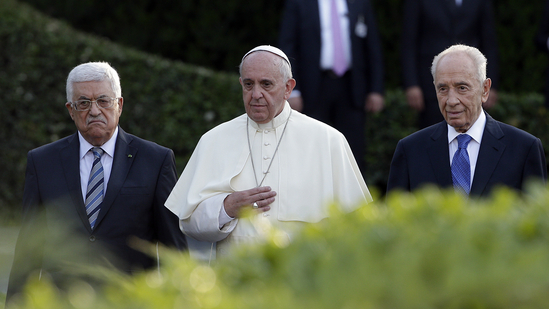 Pope Francis flanked by Israel's then President Shimon Peres, right, and Palestinian President Mahmoud Abbas during an evening of peace prayers in the Vatican, Sunday, June 8, 2014. (AP Photo/Gregorio Borgia, file)(AP)