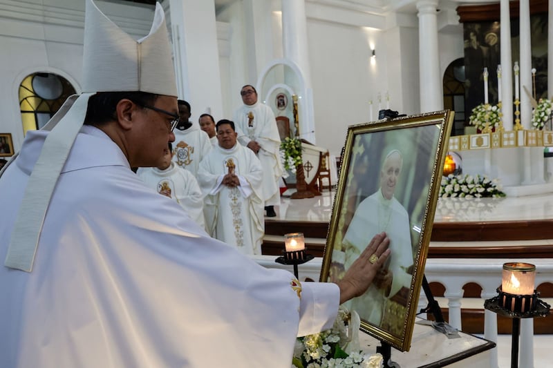 Cardinal Pablo Virgilio Siongco David, Bishop of Kalookan, touches a portrait of Pope Francis after a holy mass at the San Roque Cathedral in Caloocan City, Metro Manila, Philippines, on Tuesday. Photo: EPA
