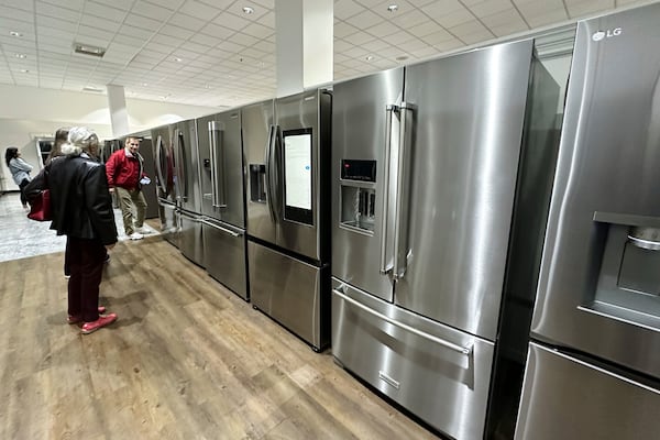 Customers shop refrigerators at a retail store in Glenview, Ill., Thursday, April 3, 2025. (AP Photo/Nam Y. Huh)