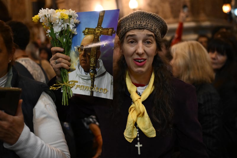 A woman holds a picture of late Pope Francis during a mass at the San Jose de Flores Basilica in Buenos Aires on Monday. Photo: Getty Images