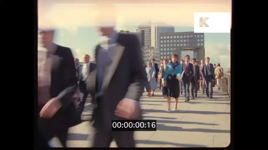 Commuters crossing London Bridge in the 1980's. Look at all those briefcases!