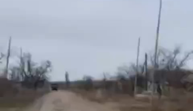 A Russian soldier films the moment a Ukrainian FPV quad hits a Ural truck while his comrades try to shoot down the UAV.