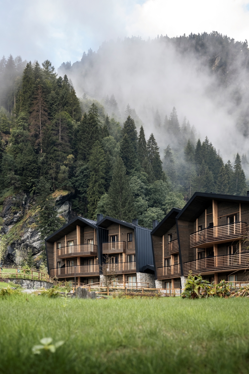 G22 projects tucks mountain village lodges amid northern italy's alpine peaks
