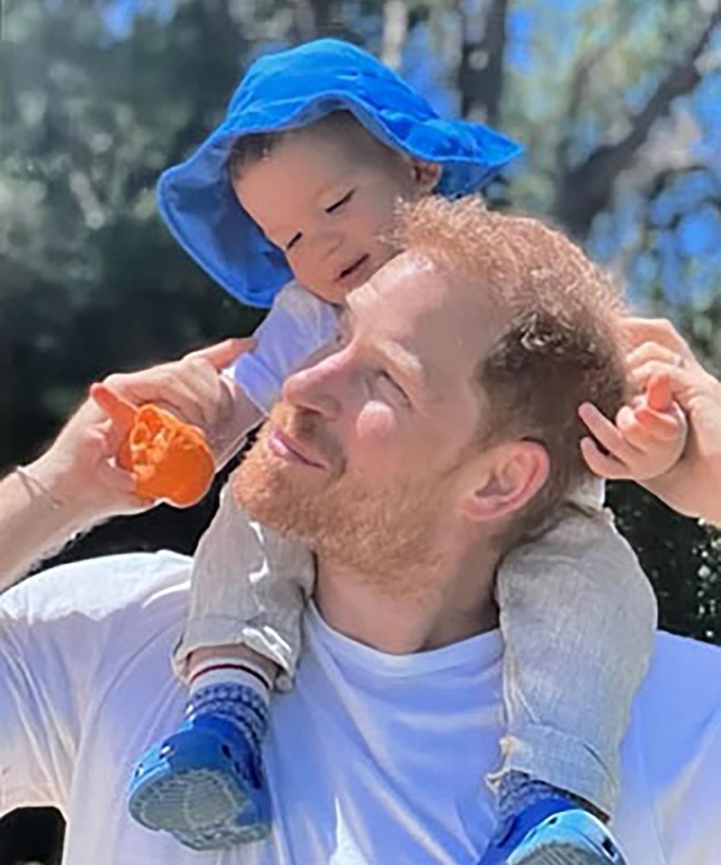 Prince Harry with his son Archie on his shoulders.
