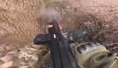 A volunteer from Brazil shoots a Russian soldier in close combat.
