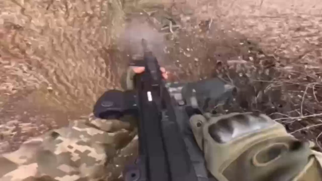 A volunteer from Brazil shoots a Russian soldier in close combat.