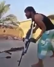 Iraqi volunteer gets his head snapped by isis sniper the moment he tries to fire his pkm, exact date/location are unknown.