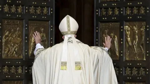 Reuters Pope Francis opens the Holy Door to mark opening of the Catholic Holy Year, or Jubilee, in St. Peter's basilica, at the Vatican, December 8, 2015.