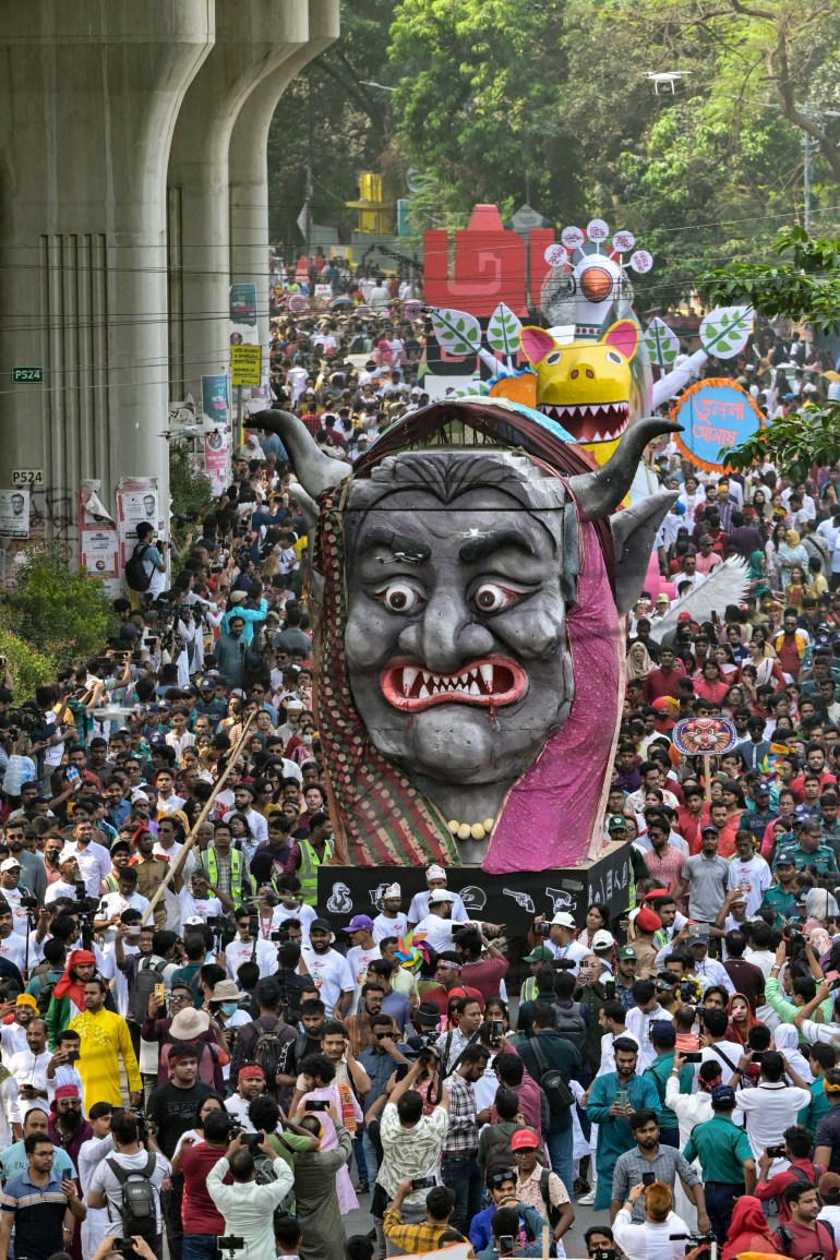 People march down a street during celebrations marking the 'Bengali New Year' in Dhaka on April 14, 2025. (Photo by MUNIR UZ ZAMAN / AFP)