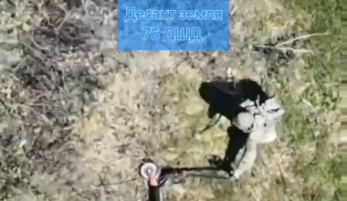 A Russian paratrooper attempts to remove his electric scooter from barbewire, but ends up dragging it over a mine. (Music from source)