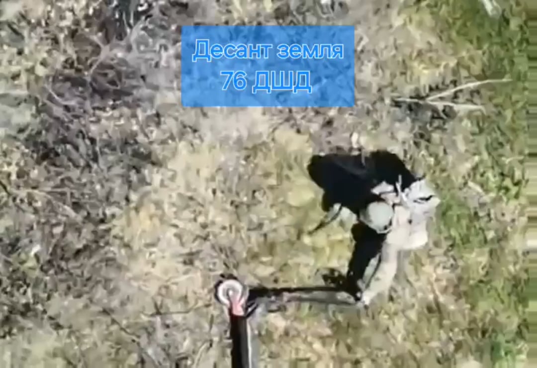 A Russian paratrooper attempts to remove his electric scooter from barbewire, but ends up dragging it over a mine. (Music from source)