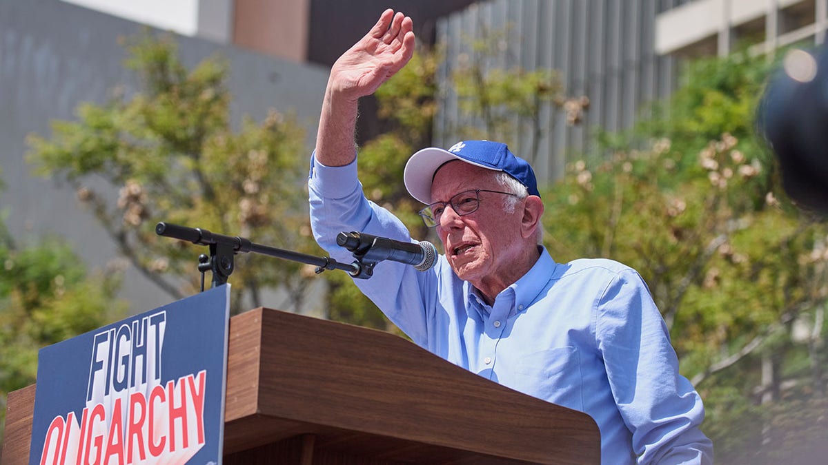 Bernie Sanders waves on stage at "fighting the oligarchy" event in LA