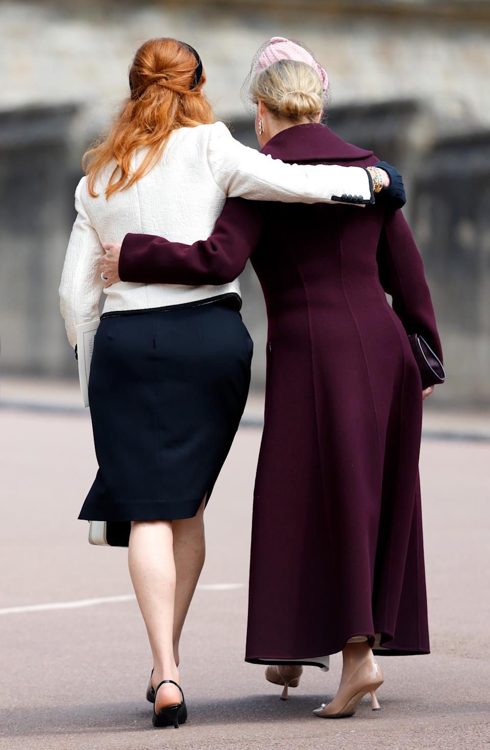 Sarah Ferguson putting her arm around Duchess Sophie walking outside Windsor Castle