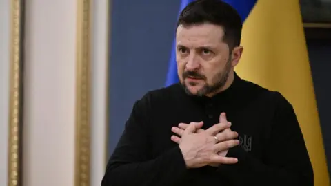 Getty Images President Zelensky holds his hands over his heart