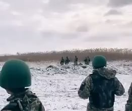 Brave Ukrainian soldiers stand in silence as they listen to the hell they will soon be sent to fight in.