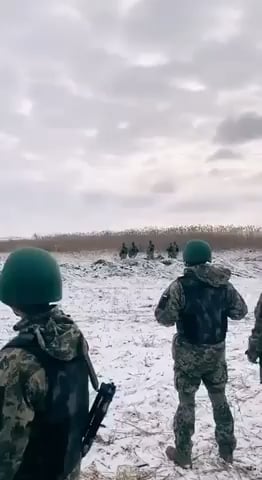 Brave Ukrainian soldiers stand in silence as they listen to the hell they will soon be sent to fight in.