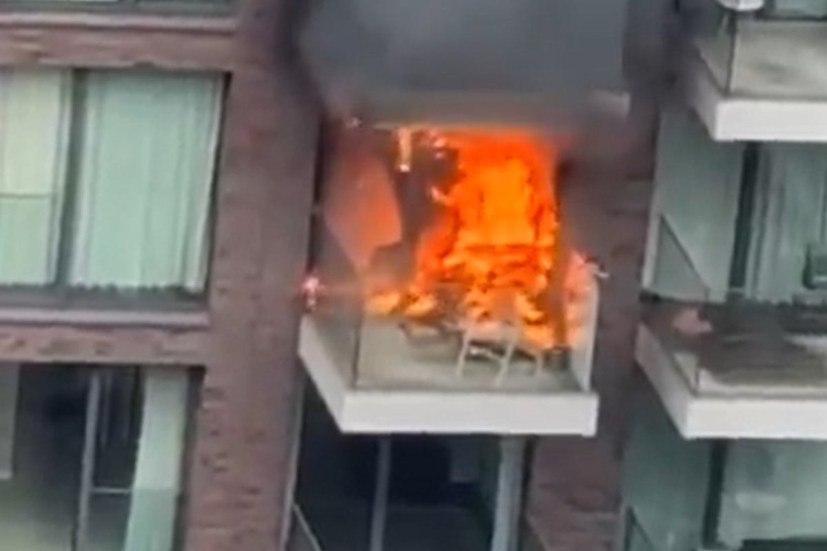 Huge fire engulfs two flats in east London block with 100 firefighters sent to scene