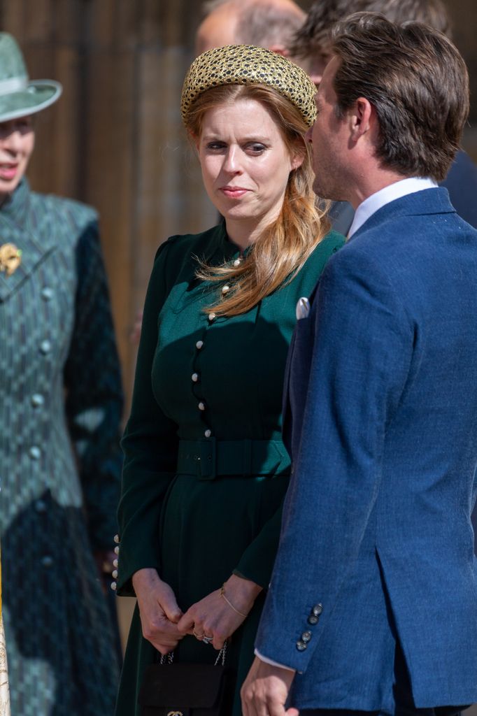 In a close-up moment, Princess Beatrice chats outside the chapel, her gold headband shimmering in the sun as her elegant green dress and mini Chanel bag complete the polished spring look.
