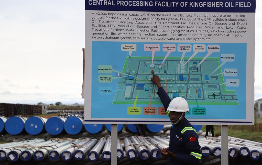 A worker shows a map of the Kingfisher Oilfield’s central processing facility in Kikube, Uganda. Photo: Xinhua A worker shows a map of the Kingfisher Oilfield’s central processing facility in Kikube, Uganda. Photo: Xinhua