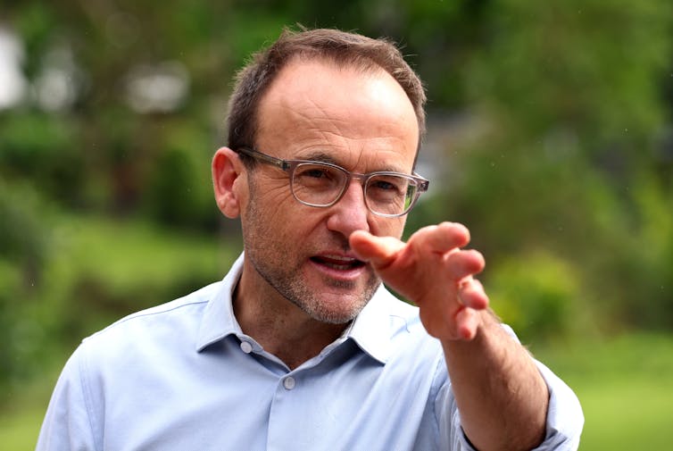 man in blue shirt pointing