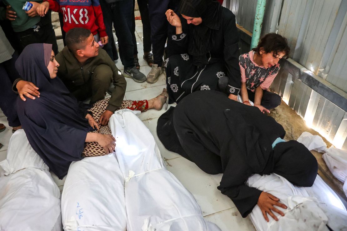 People mourn over the shrouded bodies of loved ones killed during an Israeli strike in Beit Lahia, the northern Gaza Strip on Wednesday.