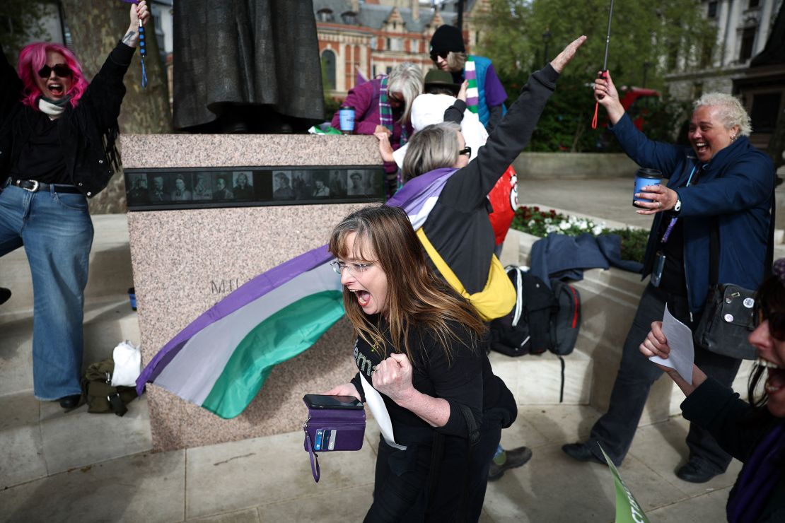 Campaigners celebrate on Wednesday, after Britain's top court delivered unanimous judgement that the definition of a woman under equality law refers to 