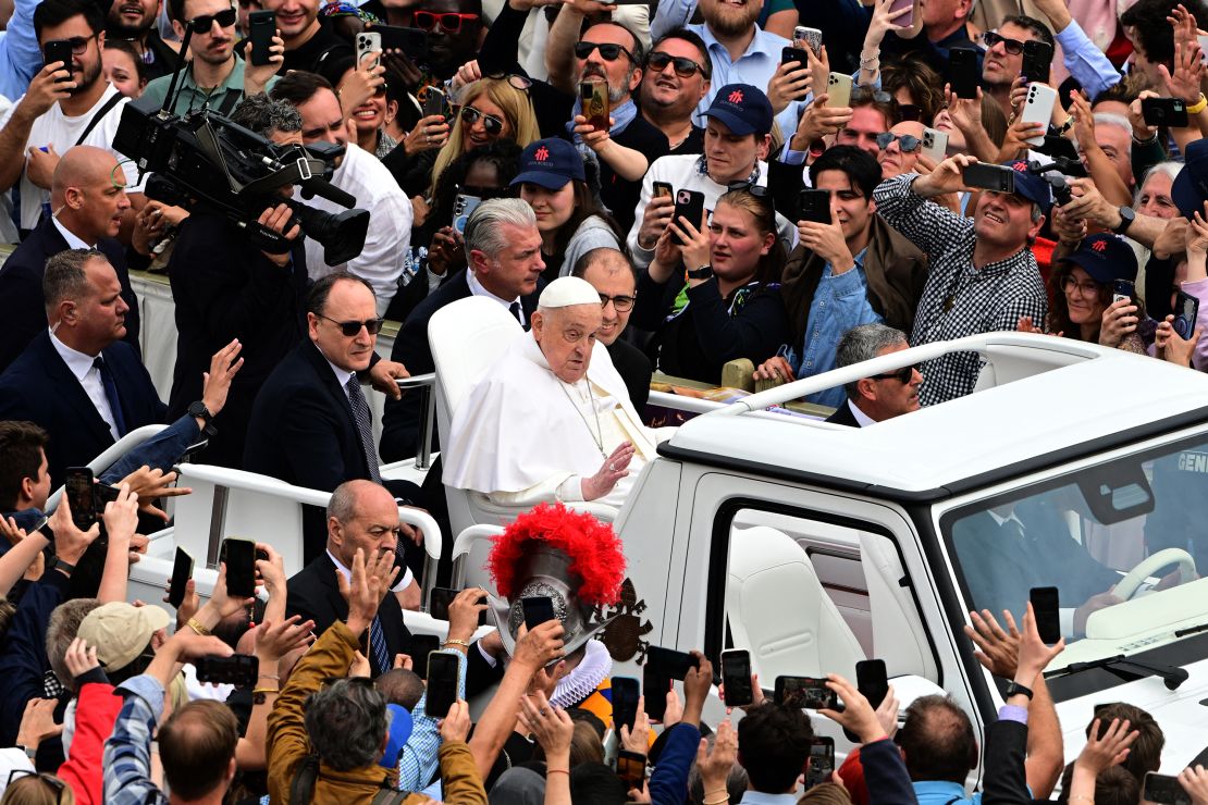 Pope Francis waves to the crowd after the Easter Mass, on Sunday.