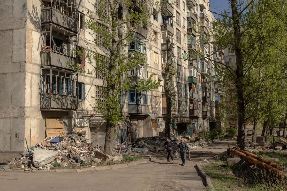 People walk through a residential neighbourhood that has been heavily damaged by air attacks in Kostyantynivka, in the eastern Donetsk region, on April 20, 2025.