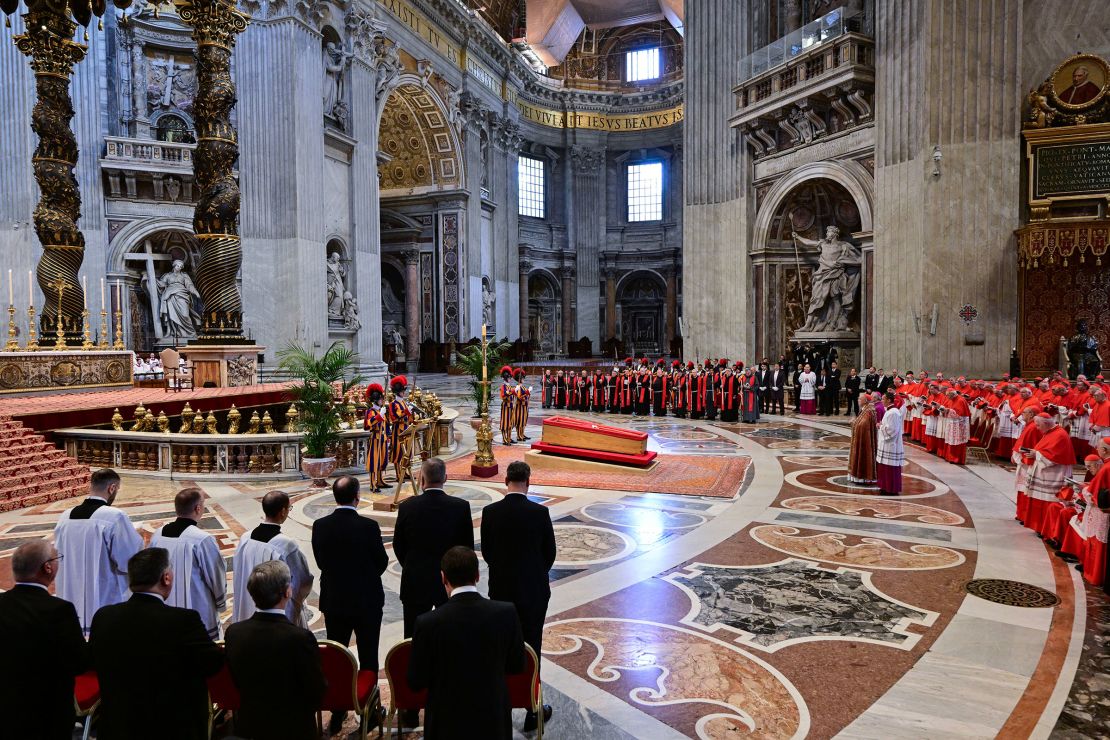 Members of the clergy stand next to the coffin of Pope Francis, inside St. Peter's Basilica on Wednesday.