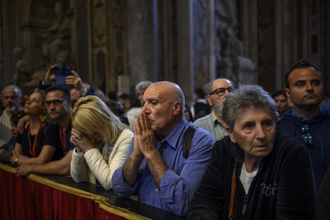 Faithful pay their respects to the body of Pope Francis on the day before his funeral in St. Peter's Square.