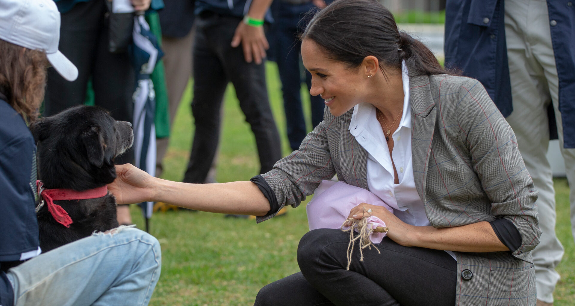 Meghan Markle wearing a gray blazer and black jeans in 2018