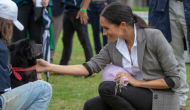Meghan Markle wearing a gray blazer and black jeans in 2018