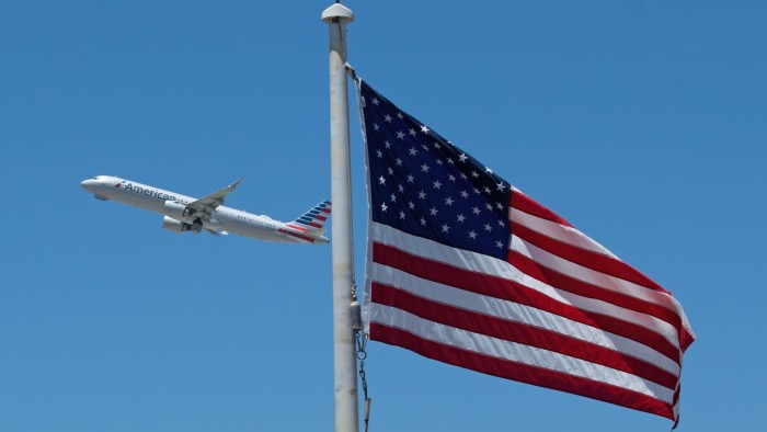 The American flag and an American Airlines jet in the distance