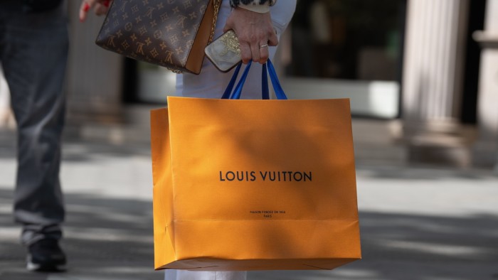 A person with a Louis Vuitton bag