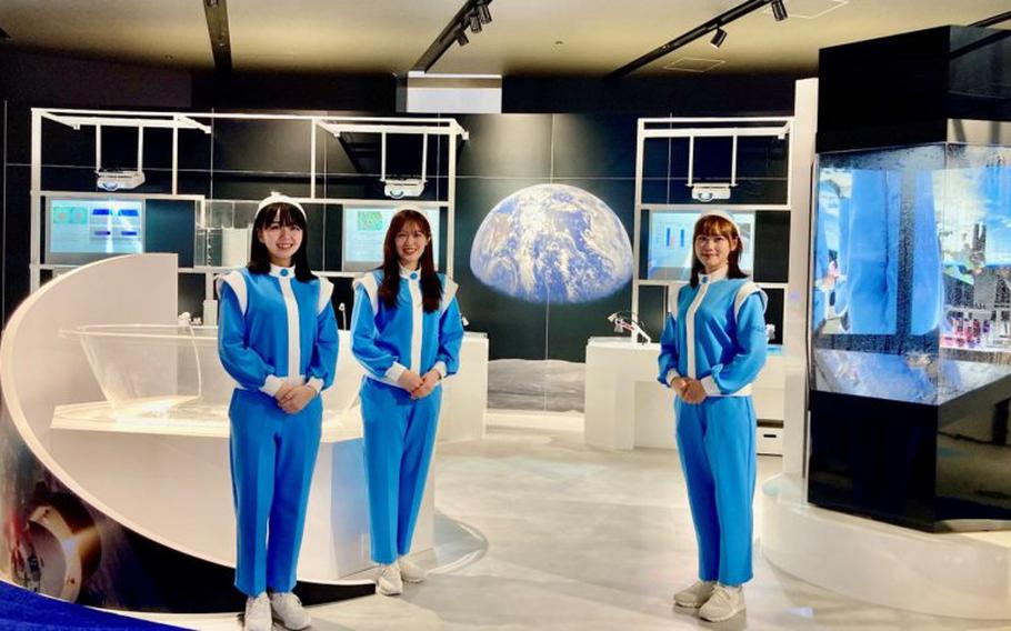 three staff members pose for a photo.