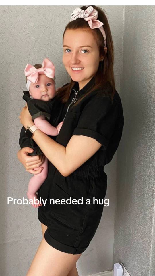 Woman holding baby.