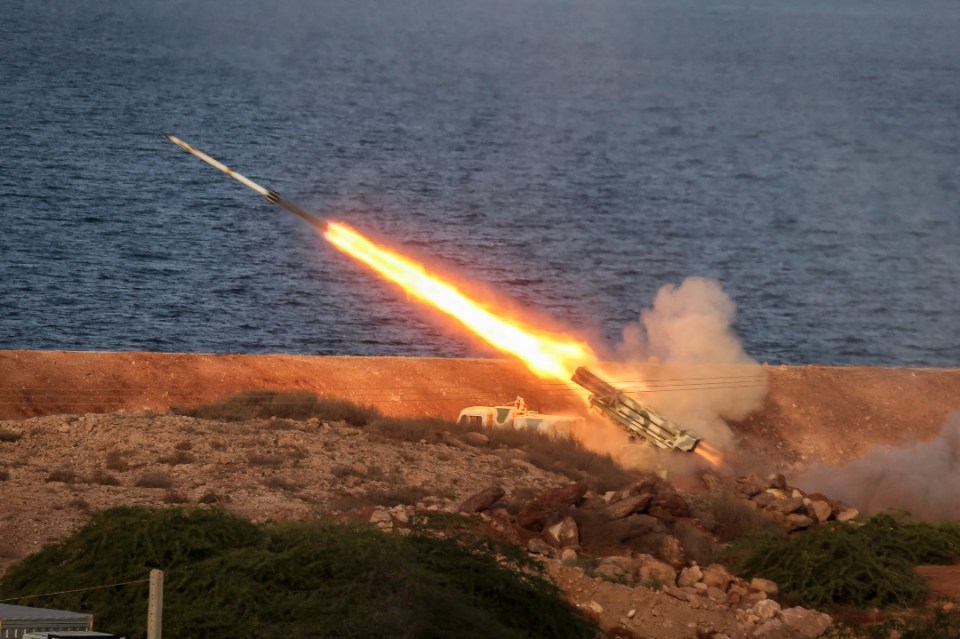 Missile launch over water.