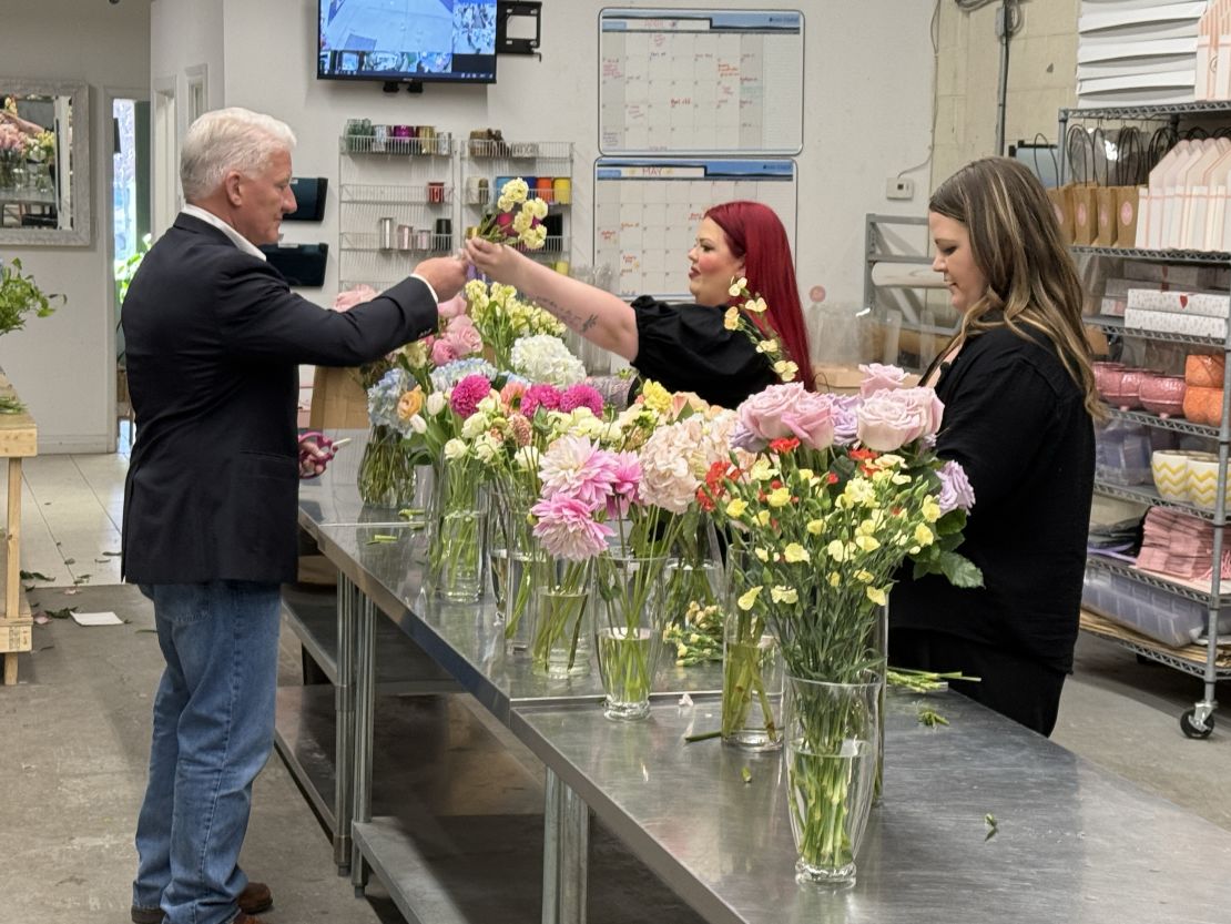 Lindsay Smith and Kaitlynn Strain, the co-owners of florist Lola Blooms, make bouquets for John King in Mississauga, Ontario.